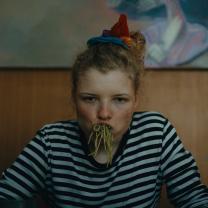 ילדה בחולצת פסים אוכלת פסטה